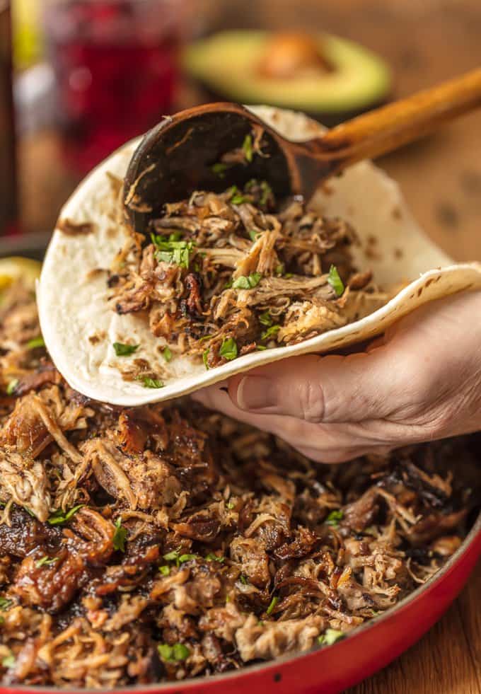 Filling a tortilla with sangria pork