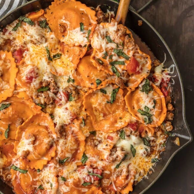 a skillet full of cheesy ravioli