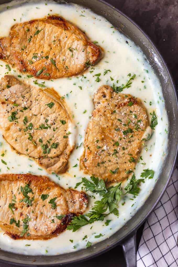 CREAMY GARLIC PARMESAN PORK CHOPS in a skillet