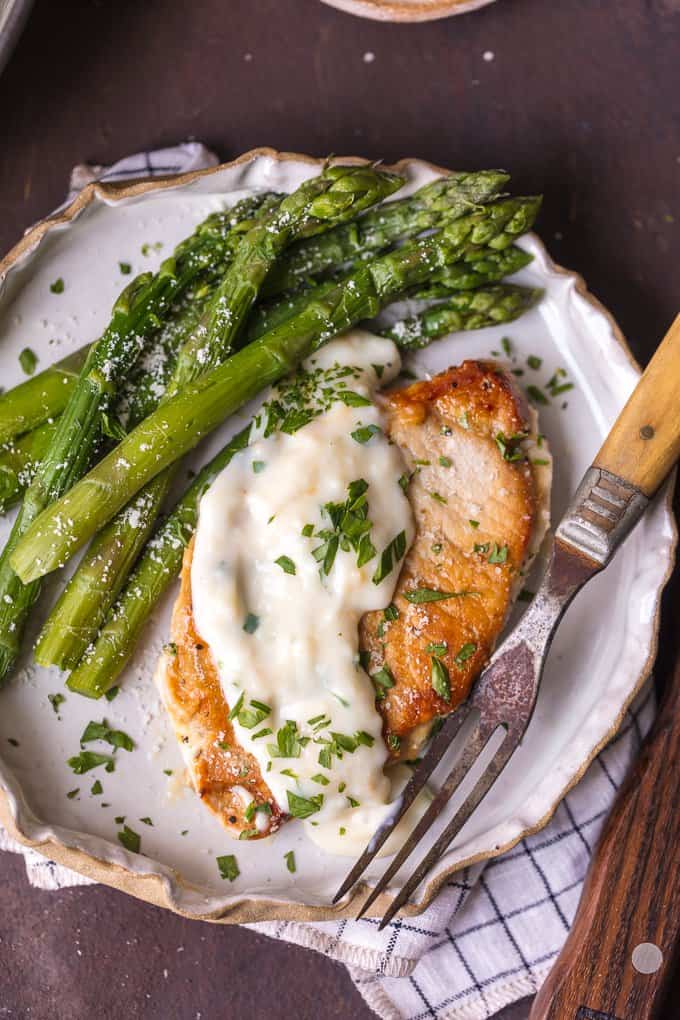 Parmesan Pork Chops with Creamy Parmesan Garlic Sauce and asparagua