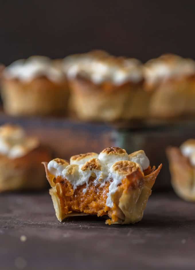 A mini sweet potato souffle cup with a bite taken out of it