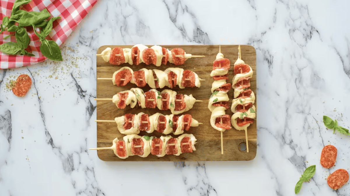 7 pizza sticks on a wooden cutting board.