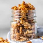 Walnuts in a glass jar with a spoon - candied walnuts.