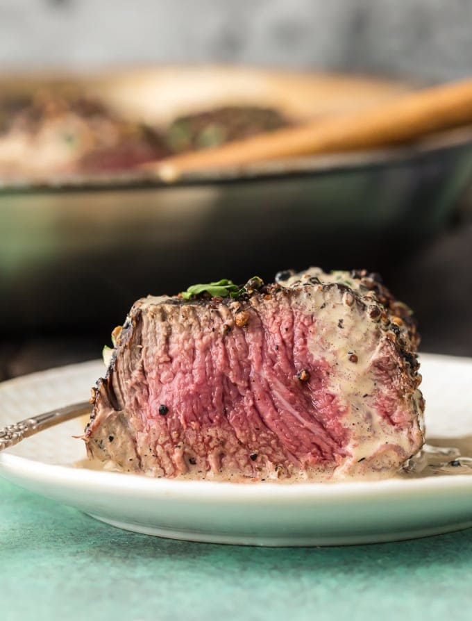 piece of steak cut to reveal medium rare interior.