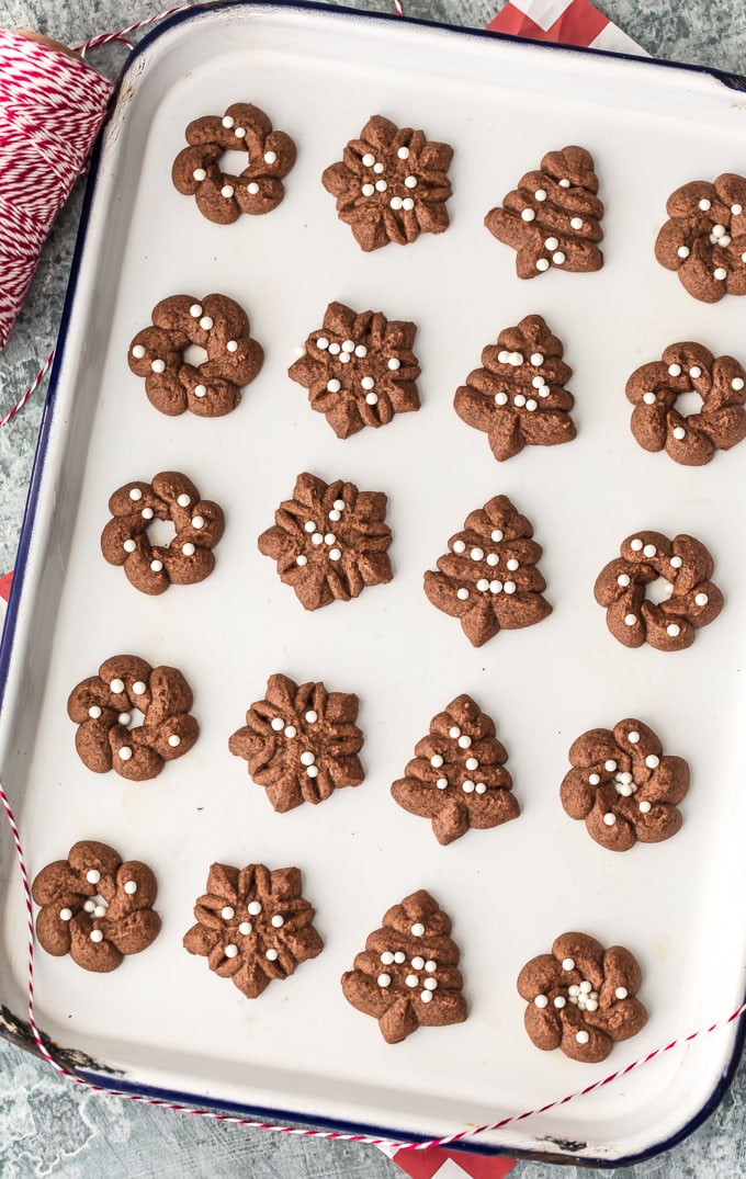 Spritz cookies arranged on a baking sheet