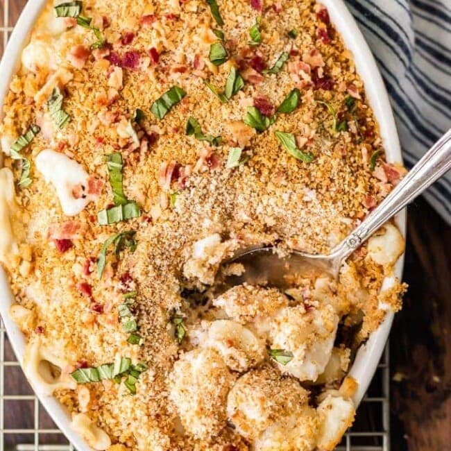 Cheesy Bacon Gnocchi Bake with a spoon on a wire rack