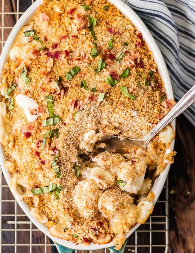 Cheesy Bacon Gnocchi Bake with a spoon on a wire rack