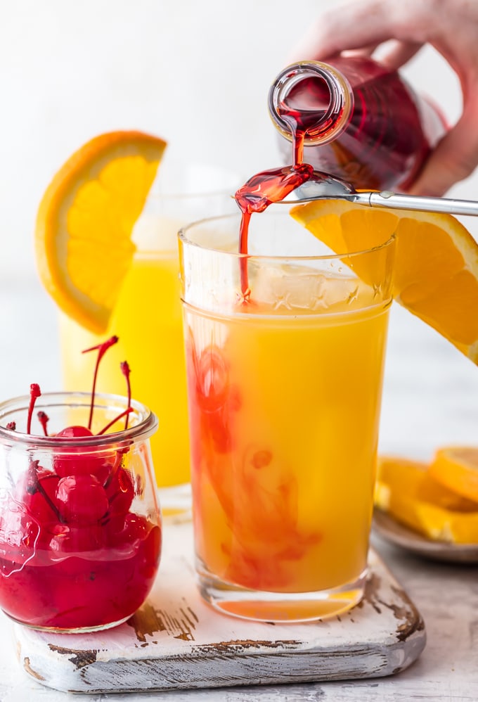 grenadine being poured into cocktail