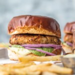 Chicken Burgers with Feta and Sun-Dried Tomato are one of my favorite healthy recipes to throw on the grill. I'm living for these FETA AND SUN-DRIED TOMATO CHICKEN BURGER RECIPE! Make these Ground Chicken Burgers by grilling on the stovetop or outdoors once the weather cooperates for the ultimate good for you comfort food. The Mediterranean flavor combo on these sandwiches is out of this world, especially when topped with an easy pesto mayo.