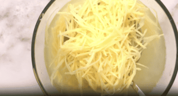 soaking julienned potatoes in a bowl of water.