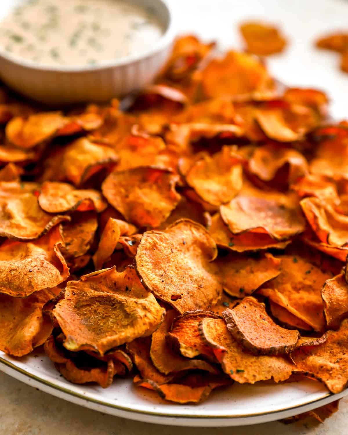 close up view of baked sweet potato chips on a platter.