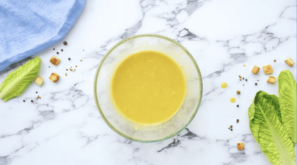 caesar salad dressing in a glass bowl.