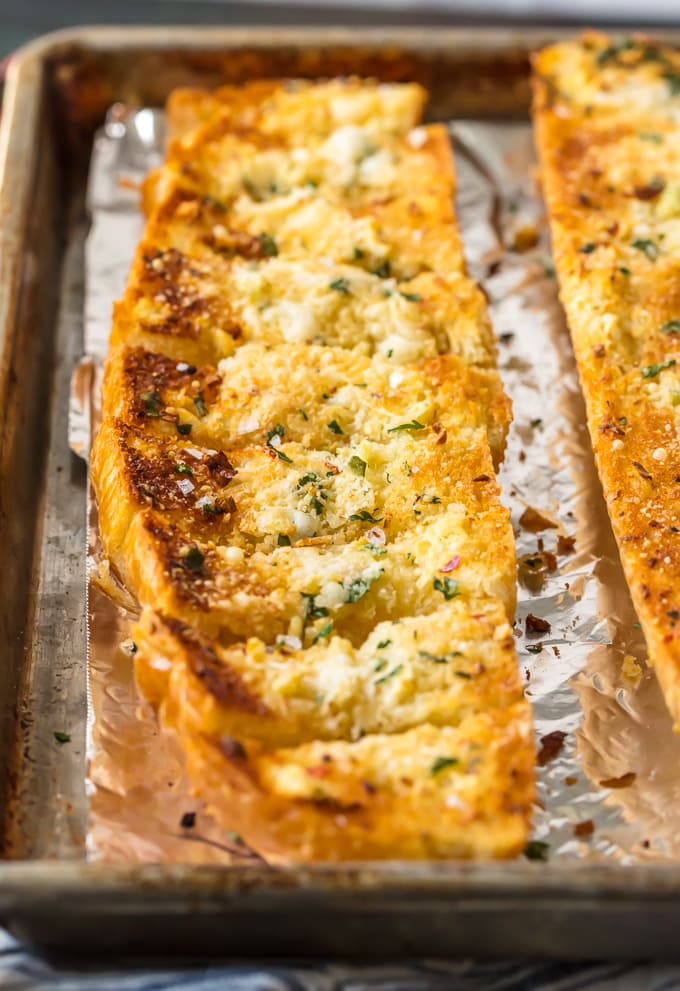 loaf of garlic bread sliced on a baking sheet