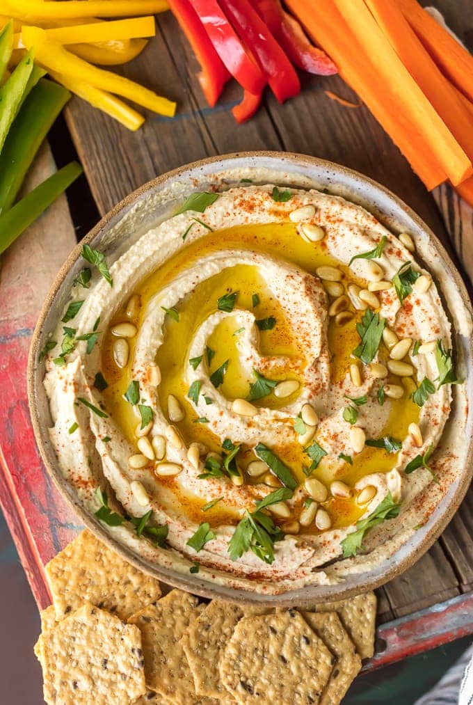 Homemade Hummus recipe: hummus on a bowl mixed with olive oil and pine nuts