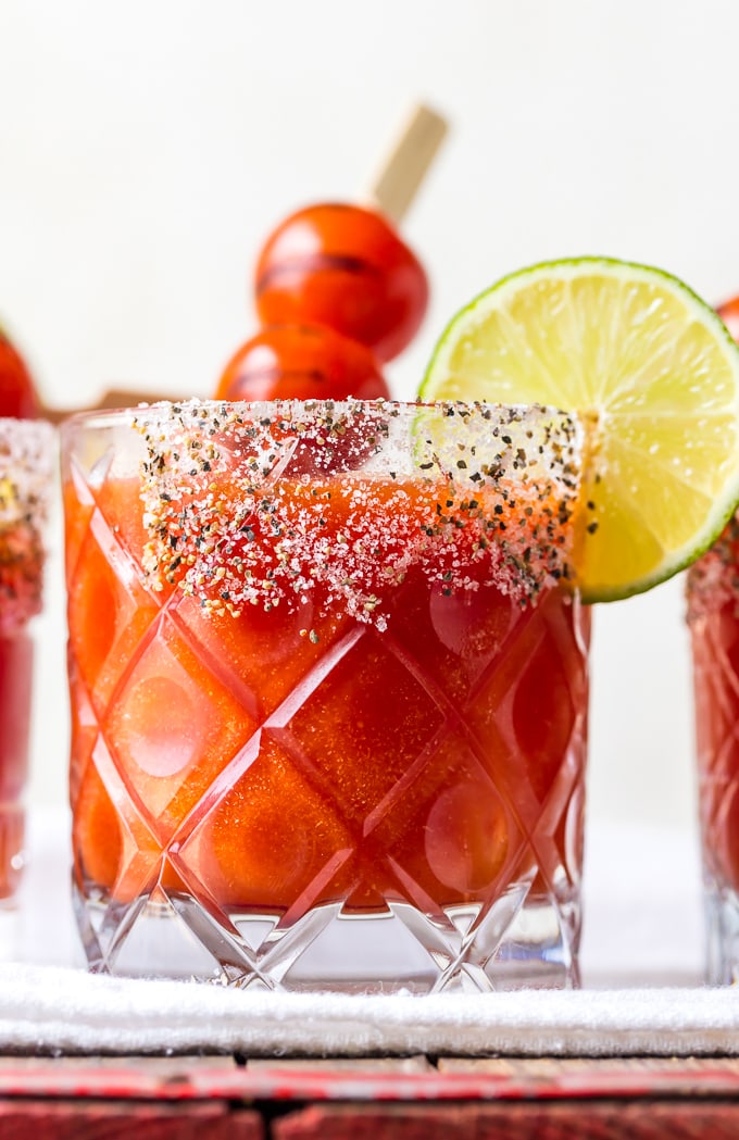 A glass of tomato margarita with a salted rim