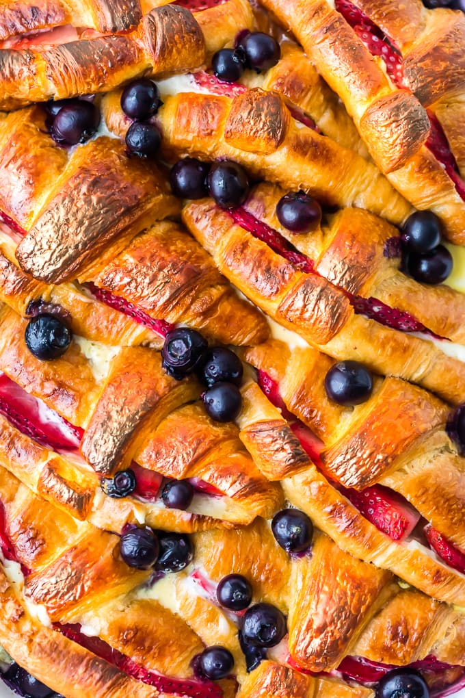 croissants, blueberries, and strawberries in a casserole dish