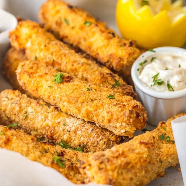 This homemade FISH STICKS recipe is baked instead of fried, making them crispy, tender, & flaky. These baked fish sticks aren't complete without homemade tartar sauce!