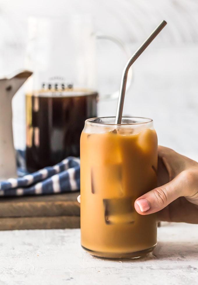 hand holding a glass of iced coffee