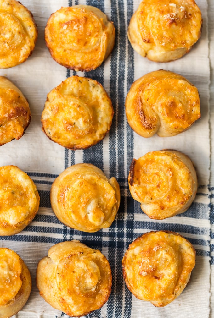 Cheesy Garlic Rolls lined up on a dish towel