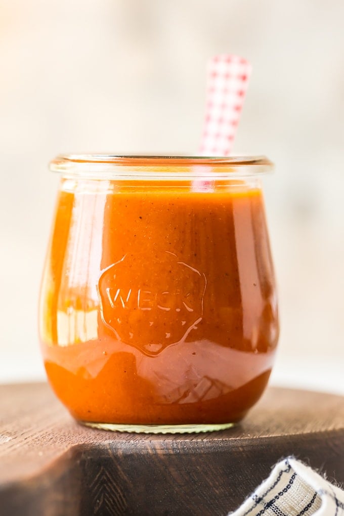 A close up of a glass of buffalo sauce