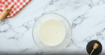 foamy milk in a glass bowl.