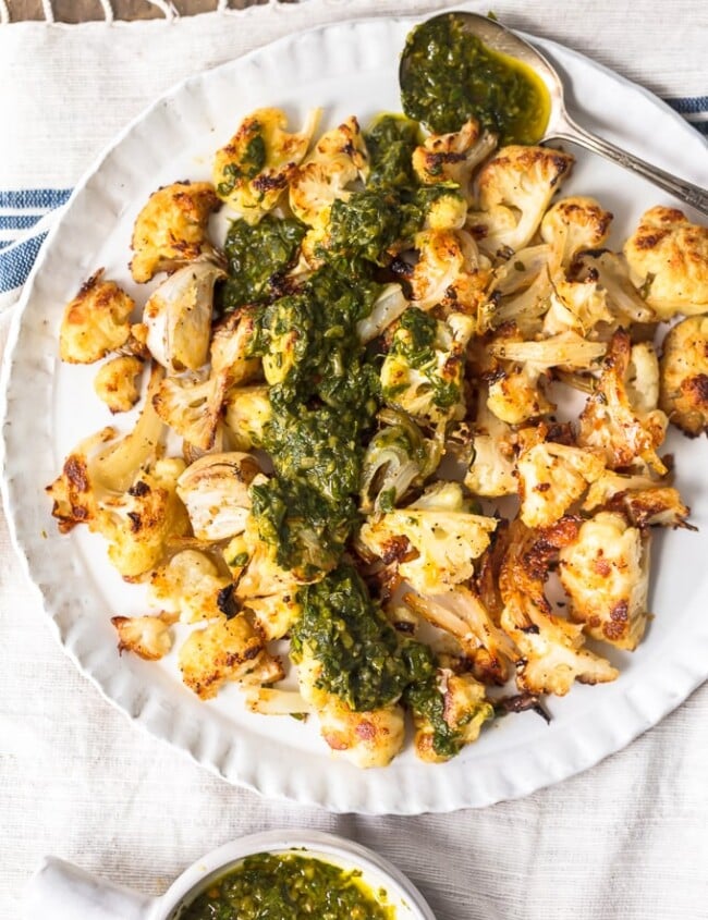 Roasted Cauliflower is a healthy and versatile side dish perfect for any meal. This cauliflower side dish with chimichurri sauce is so crispy and flavorful!