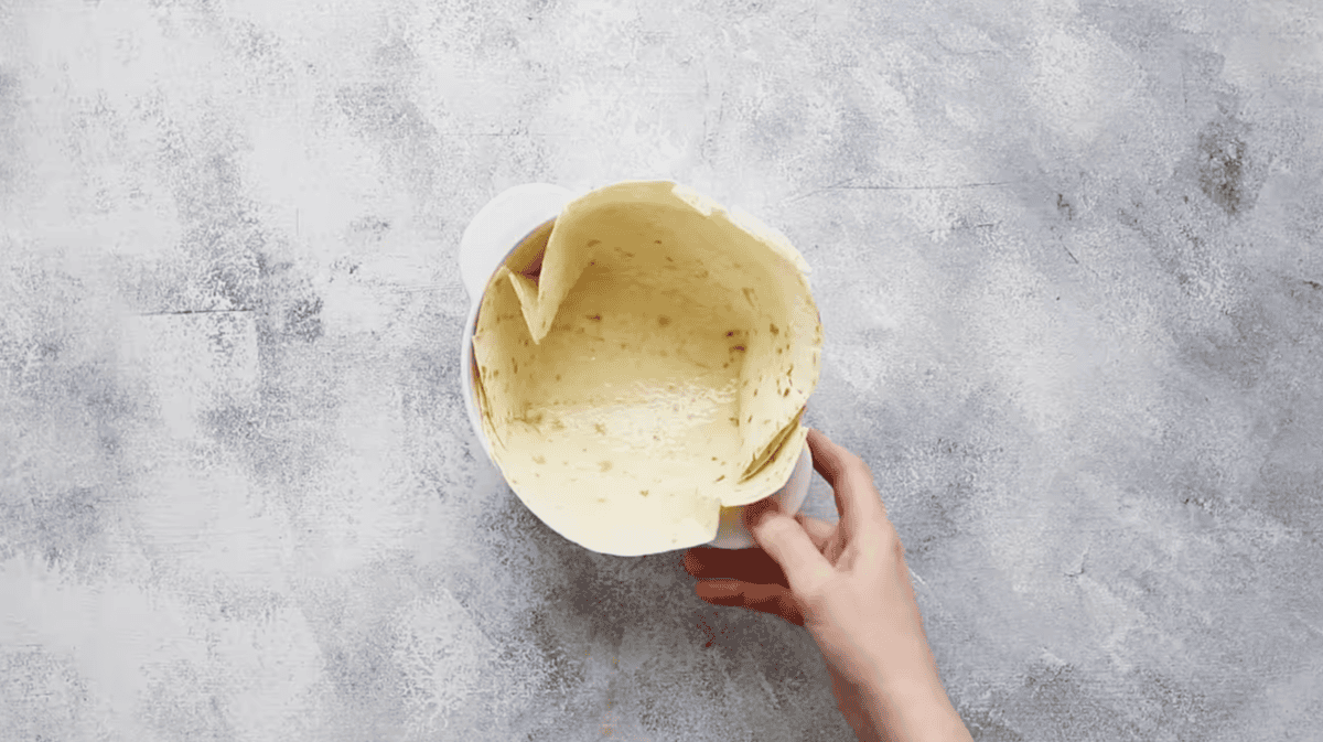 forming a tortilla into a bowl.