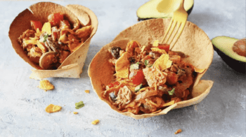 taco salad bowls topped with dressing.