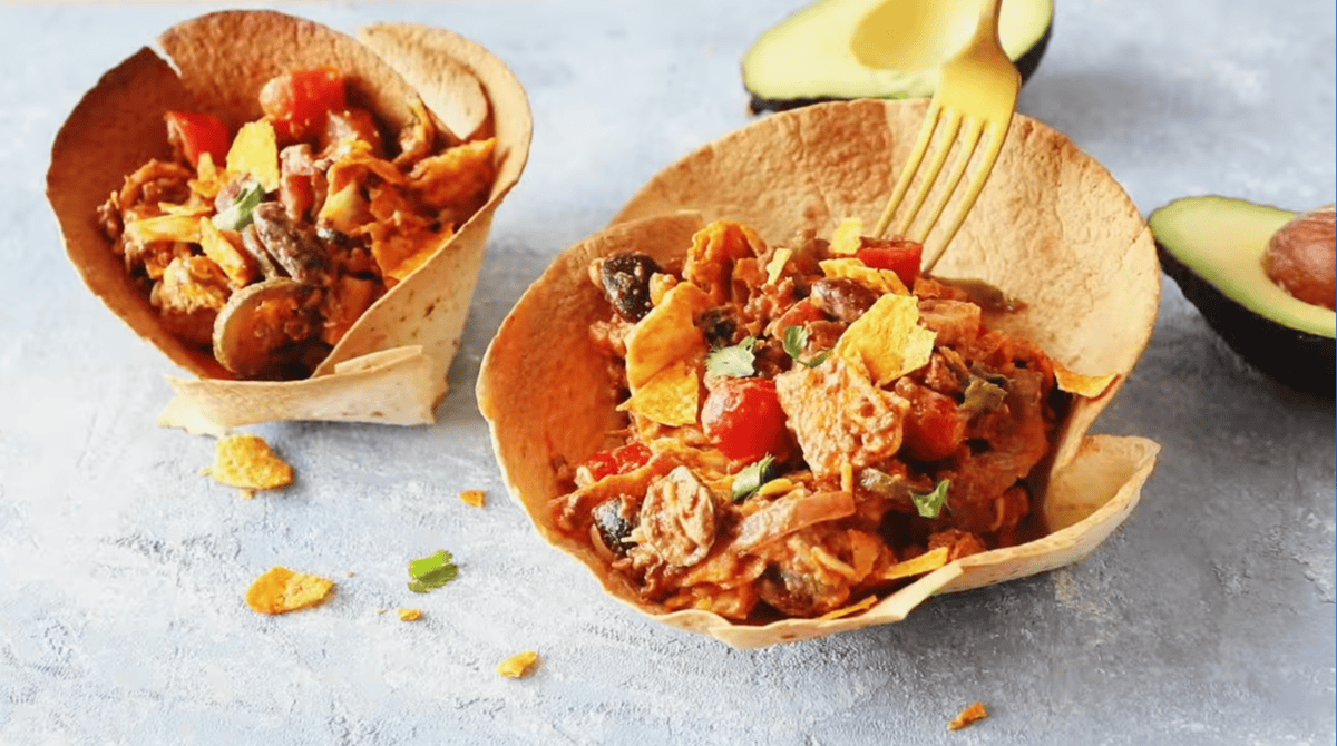 taco salad bowls topped with dressing.