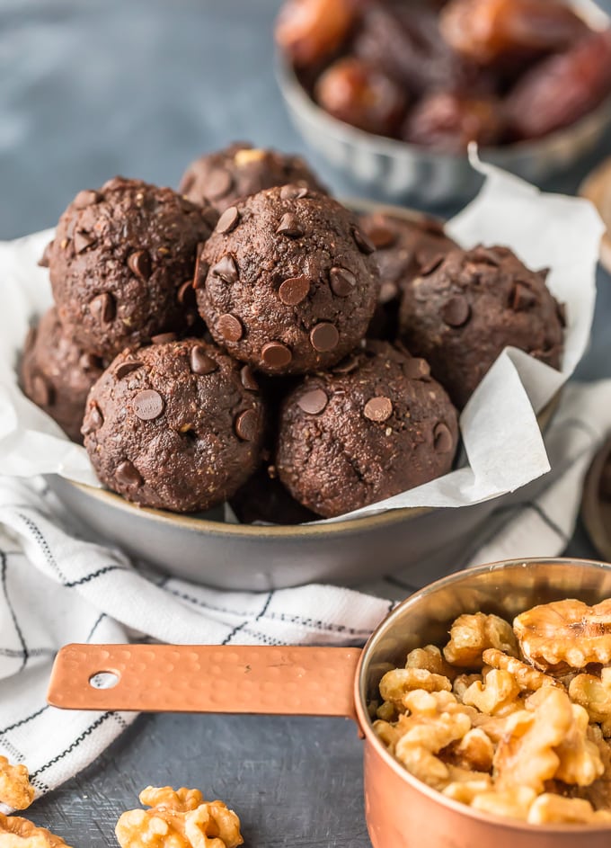 Walnut Brownie Protein Balls next to a cup of walnuts