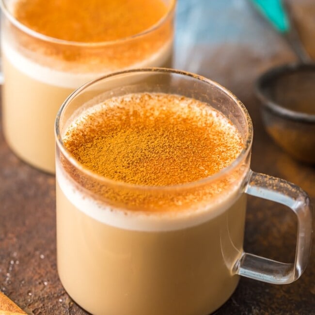 Two cups of bulletproof coffee with cinnamon and cinnamon sticks.