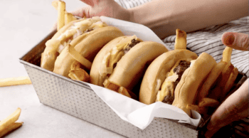 3 butter burgers in a loaf pan with fries.