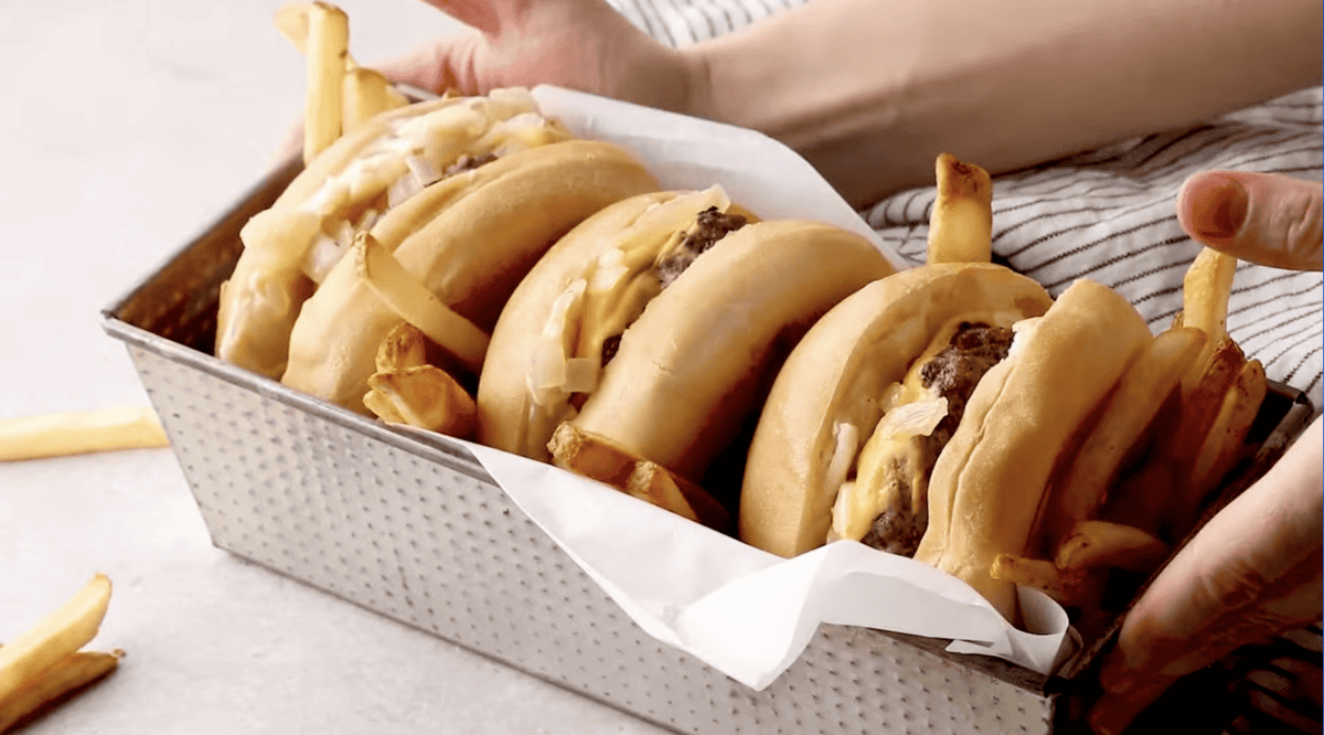 3 butter burgers in a loaf pan with fries.