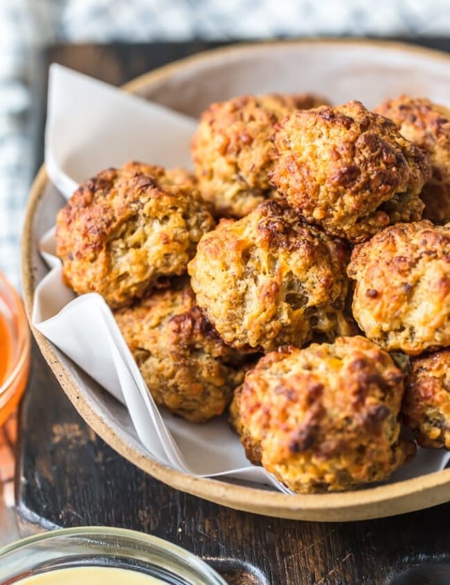 This classic Sausage Balls recipe is savory, cheesy, and tasty! These Bisquick sausage balls are the perfect appetizer for holidays or game day. Serve them with apricot sweet chili dipping sauce!