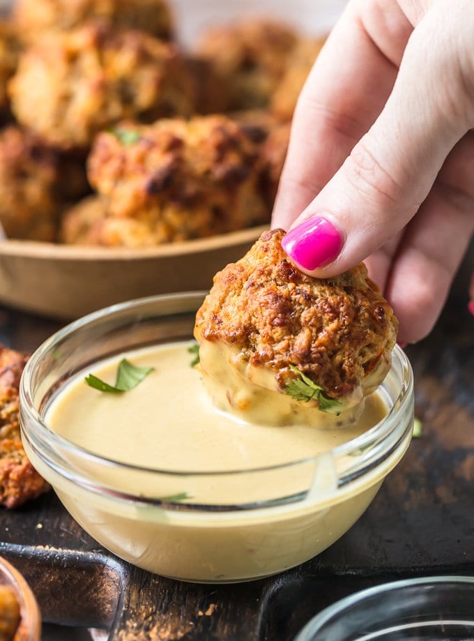 Dipping a sausage ball into honey mustard sauce