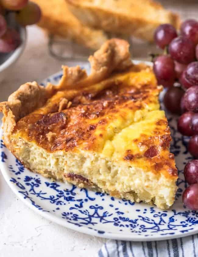 slice of quiche lorraine on a blue plate