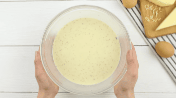 seasoned raw eggs in a glass bowl.