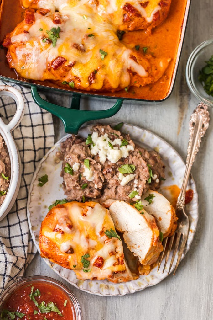 A plate of southwest baked chicken with a side of refried beans