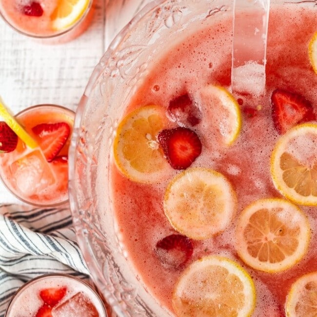 Strawberry Lemonade Party Punch is the best summer punch recipe! This refreshing drink is made with Everclear for the perfect party punch recipe.