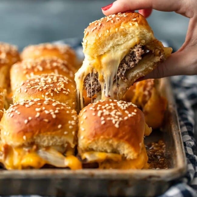 Baked Bacon Cheeseburger Sliders are a fun and easy lunch of dinner perfect for those busy school nights or fun game days! There's nothing better than this EASY Pull Apart Cheeseburger Slider Recipe for feeding a hungry crowd. So much cheese, so little time!