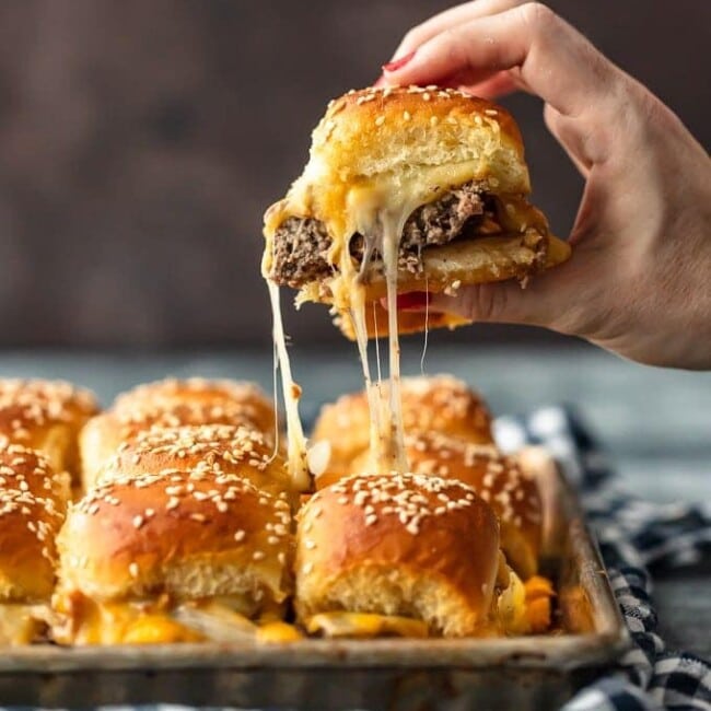 Baked Bacon Cheeseburger Sliders are a fun and easy lunch of dinner perfect for those busy school nights or fun game days! There's nothing better than this EASY Pull Apart Cheeseburger Slider Recipe for feeding a hungry crowd. So much cheese, so little time!