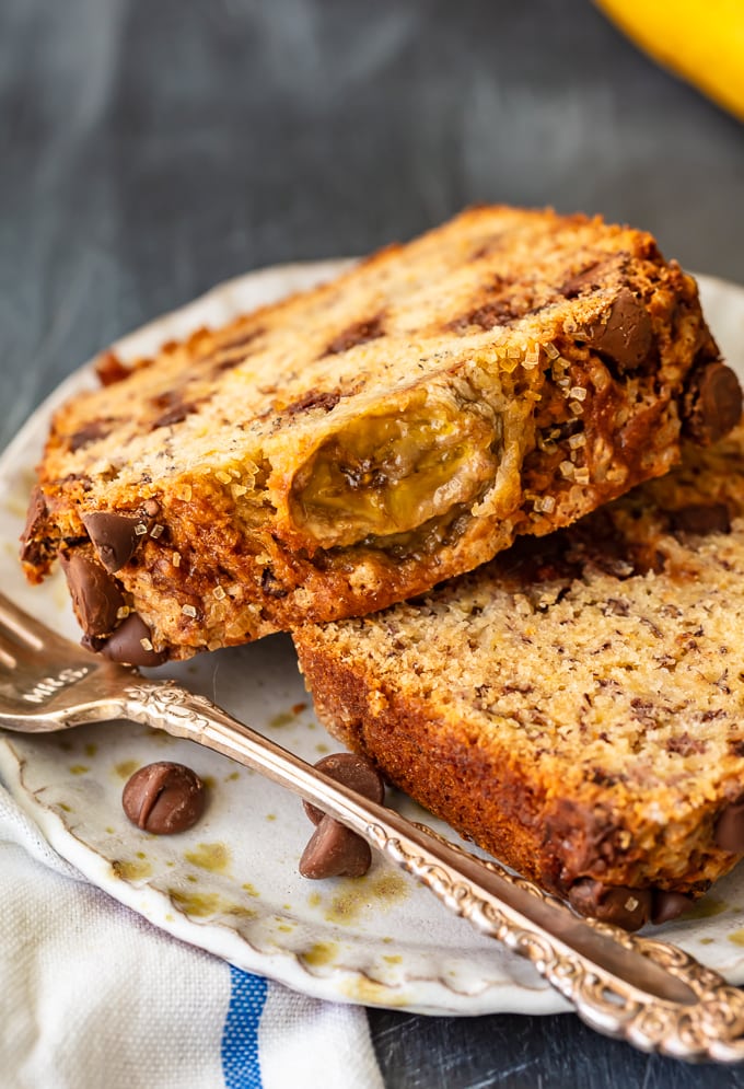 Two slices of chocolate chip banana bread on a white plate