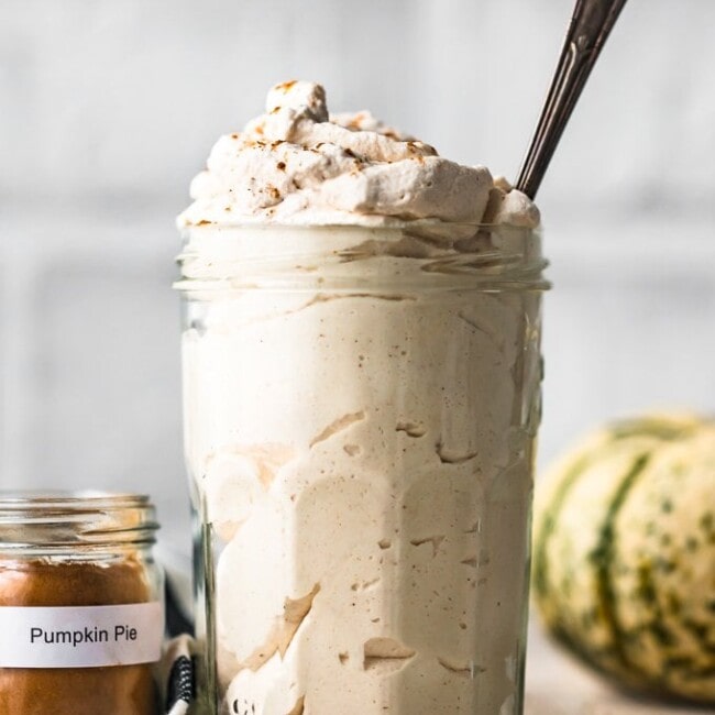 Pumpkin Flavored Whipped Cream is exactly what we all need for fall! Top of all of your favorite desserts (pumpkin pie, pumpkin cheesecake, pumpkin anything) with this Pumpkin Spice Whipped Cream recipe.