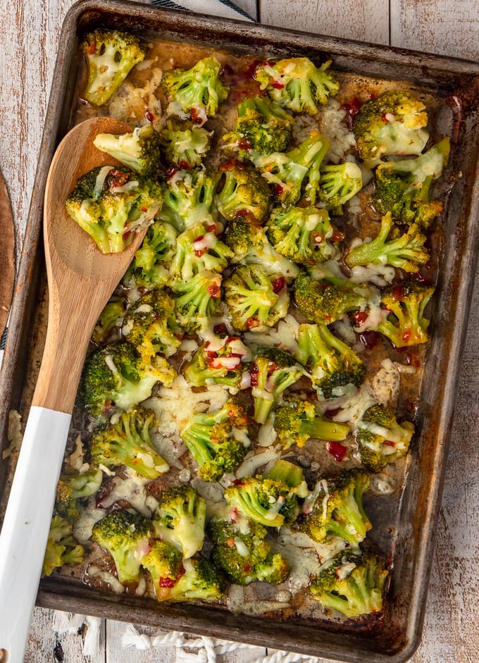 spicy cheesy broccoli on a baking sheet