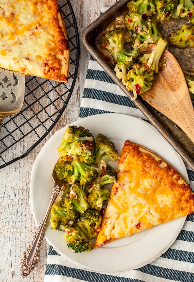 cheese pizza and broccoli on a plate