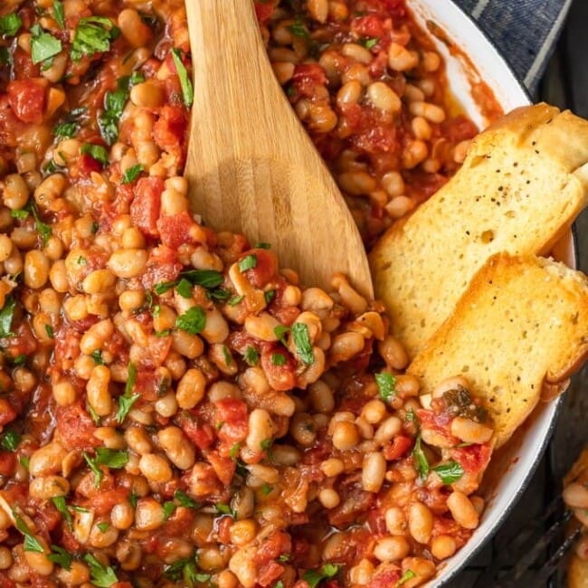 This White Beans recipe is so simple, yet so delicious! Cannellini beans cooked with tomatoes, garlic, and chicken broth make for one tasty side dish. It's perfect for holidays or easy weeknight meals!