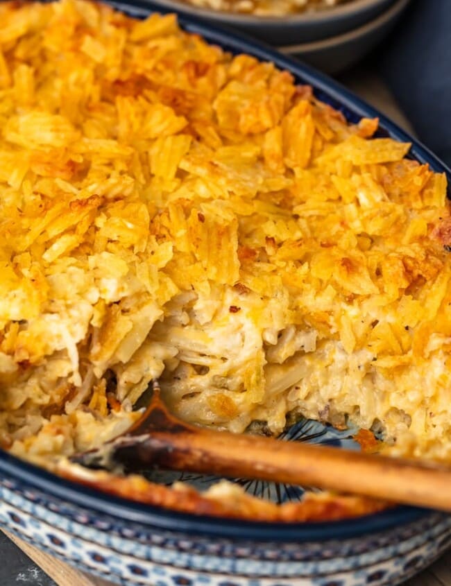 Cheesy Potato Casserole is the ideal holiday side dish recipe for anyone that loves cheese and potatoes. This hash brown potato casserole recipe is super easy, super cheesy, and topped off with a crunchy potato chip topping!