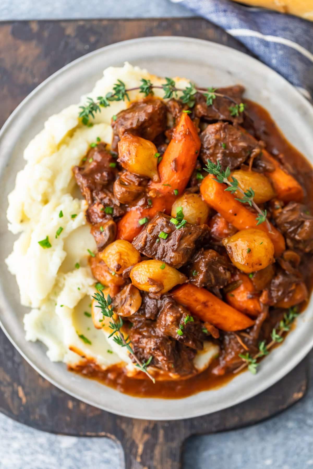 a plate of beef bourguignon with mashed potatoes