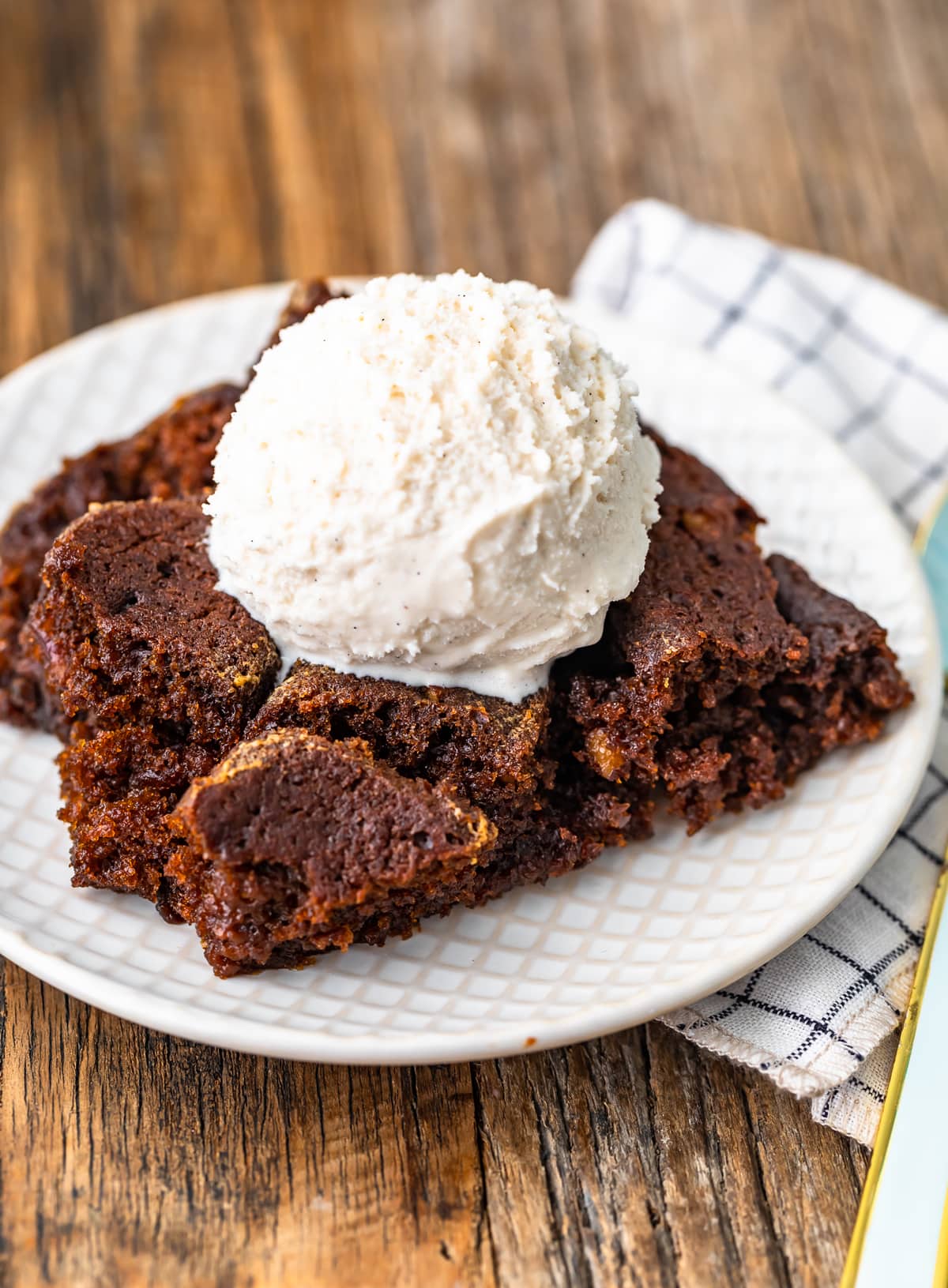 close up view of gingerbread pudding cake and ice cream on a plate