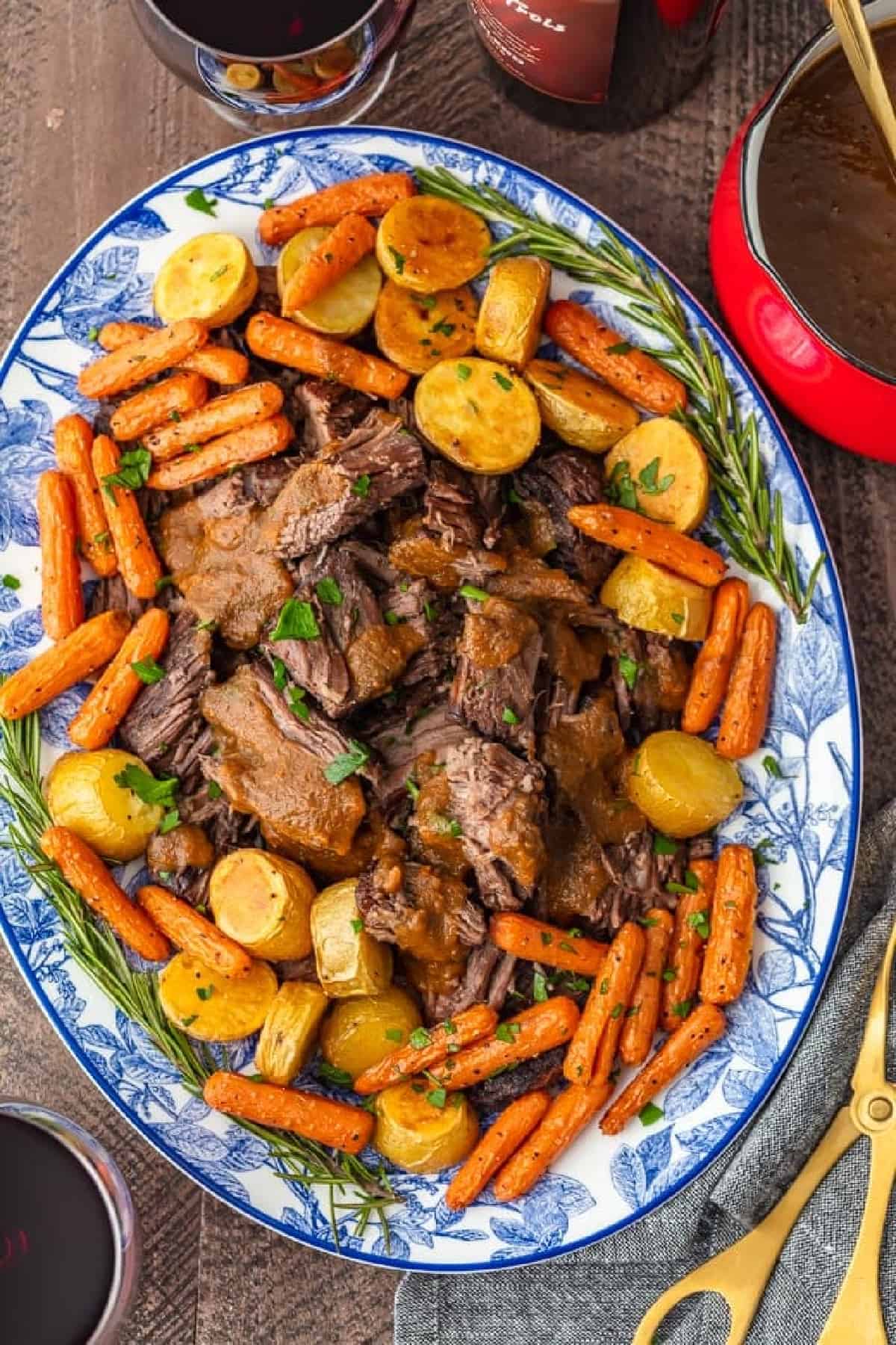 A plate of Christmas pot roast with carrots and gravy.